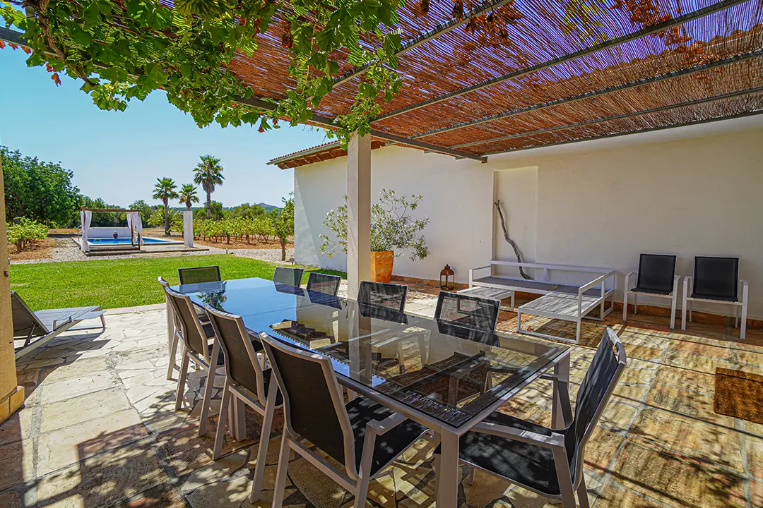 Covered terrace with dining table at Finca Mia Limon on Mallorca